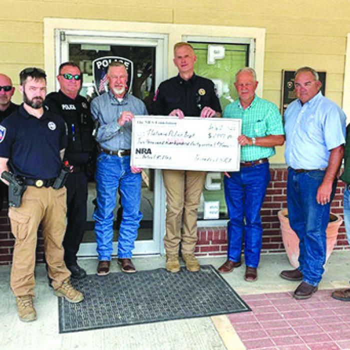 Tri-County Friends of the NRA presented a grant to the Flatonia Police Department for the purchase of new patrol rifles. Pictured are Officer Taylor Amos, Officer Wilbert Kalina, Sergeant Trey Tunis, Officer Jason Bellah, Flatonia City Manager Raymond Miller, Chief Lee Dick, and Tri-County Friends of NRA representatives Dennis Brower, Craig Schulz, and Jeremy Stoever.