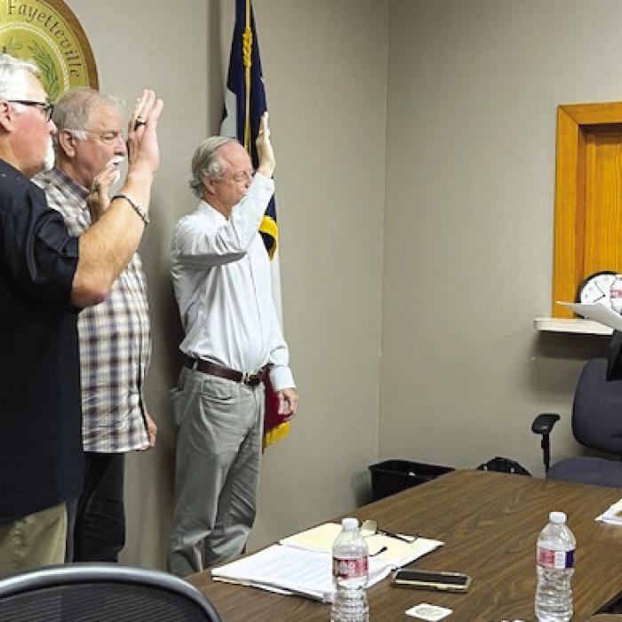 From left: City Councilman Kelly Brooks, Mayor Mike Stroup and City Councilman Cade Burks were sworn in for their new terms by JP Jamie Moreau.