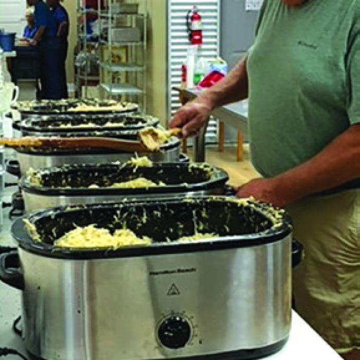 Paul Hechler stirring the sauerkraut at the St. Mary’s Bazaar.