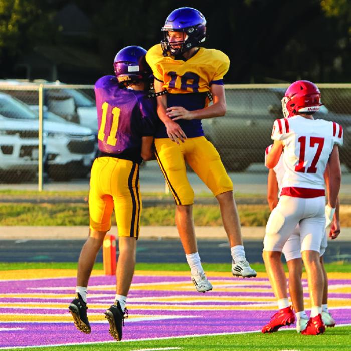 Receiver Ethan Prasek, left, and quarterback Quade Brothers celebrate their touchdown. Photo by Darrell D. Gest