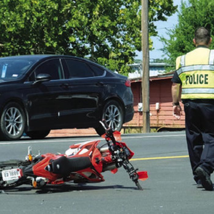 La Grange Police direct traffic following the motorcycle accident at the intersection of SH 71 Business and Country Club Dr. last Thursday.