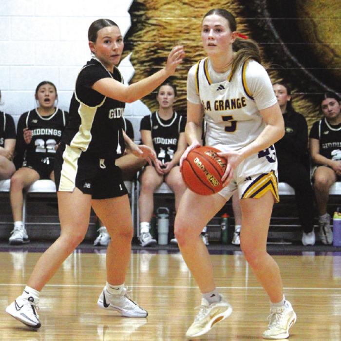 La Grange’s Campbell Cooper, right, looks to make a pass in Tuesday’s game. She scored a team-high 21 points. Photo by Jeff Wick