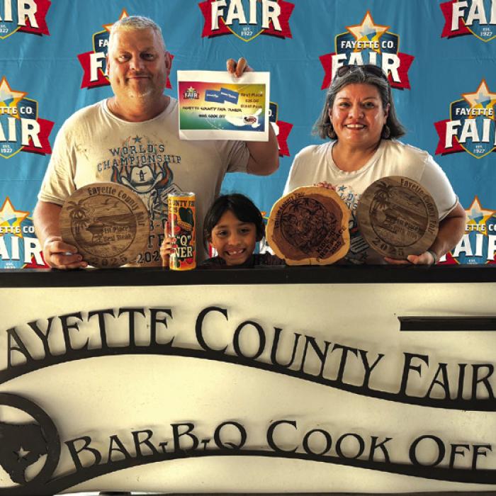 Jason and Nicole Vasut, and Nicole’s daughter Reeanna Ramirez front, showing off their wins at the Fayette Co. Fair BBQ Cookoff. Reeanna will also be competing in Houston in the Kids Cookoff. This will be the first time for Fayette County to have a kid compete at nationals.
