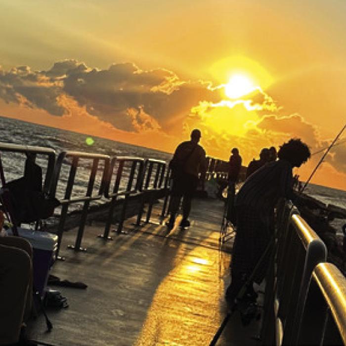 Fishermen line the Packery Channel jetty just after sunrise Friday. Photos by Joe Sample