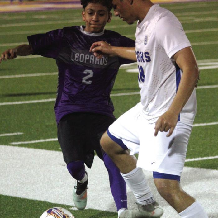 La Grange’s Jared Hernandez, left, fights for control of the ball in Tuesday’s match. Photo by Jeff Wick