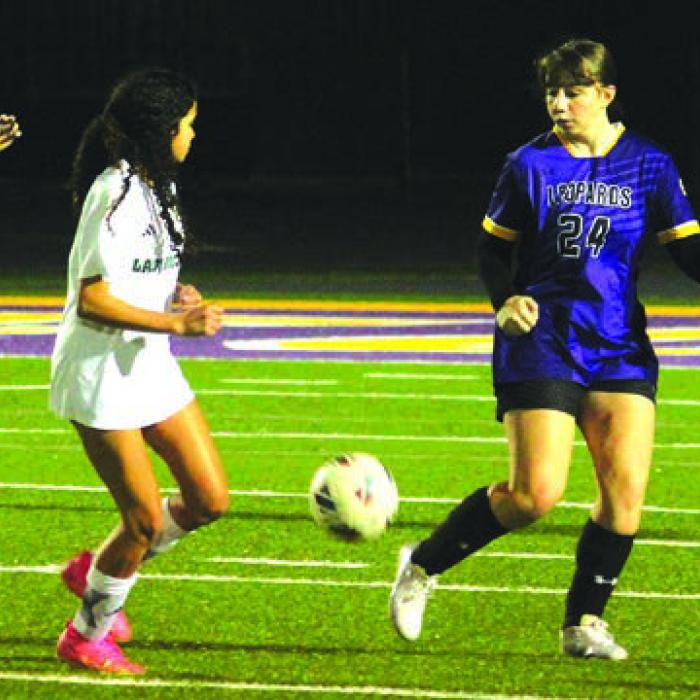 La Grange’s Meadow Taylor-Marklin on defense in the left photo and Florencia Barron on offense in the right photo during Tuesday’s game.