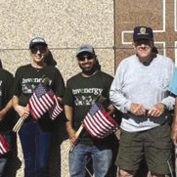 Volunteers from Invenergy assisted American Legion Post 143 of Schulenburg to place flags on the graves of deceased veterans ahead of Memorial Day.