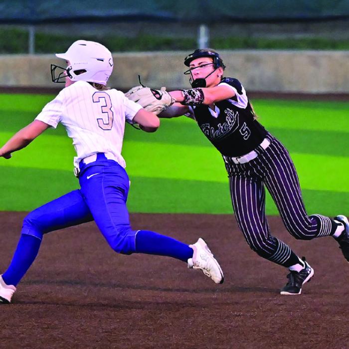 Senior second baseman Sadie Noska fields a ground ball, tags the runner and throws to first for the double play in Friday night’s game with Holland. Photo by Stephanie Steinhauser