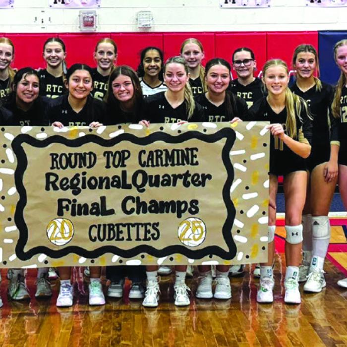 The members of the Round Top-Carmine volleyball team celebrate their regional quarterfinal victory over Chester Thursday in Madisonville.
