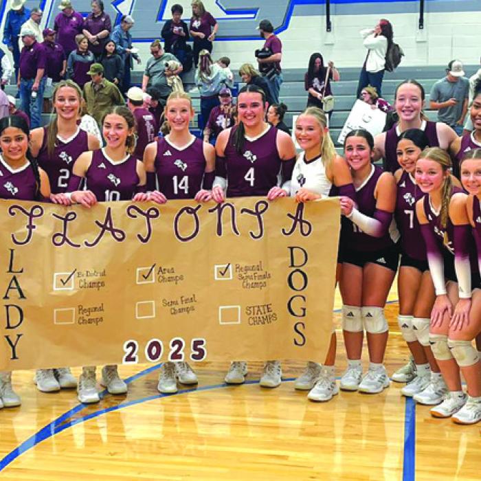 The members of the Flatonia volleyball team check off another box in their playoff banner as they celebrate their regional semifinal playoff victory over Refugio Thursday in Edna.