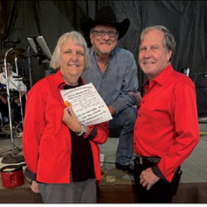 Jan Koehn and Gary Bucek presenting the Majek Wine Gift Card to Band Leader, Kenneth Kristynik.