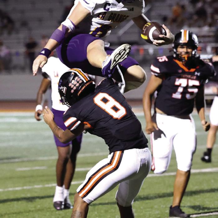 La Grange quarterback Clayton Cooper made the play of the year so far for the Leps as he hurdled this would-be Smithville tackler in Friday’s 52-7 victory Lots more on the big win in Section B today. Photo by Katy Michalke
