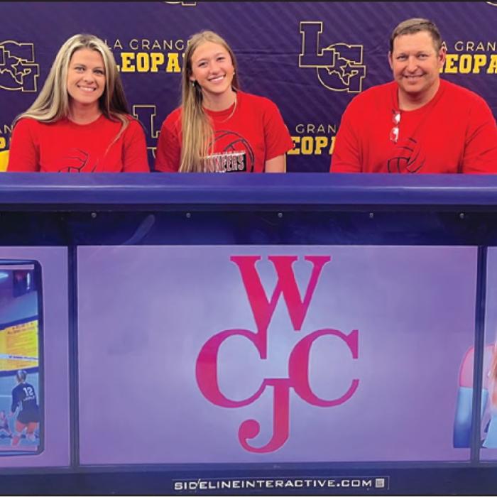 La Grange’s Carley Ulrich is shown here, center, at her signing ceremony Wednesday as she inked a deal to play volleyball for Wharton County Junior College. She is seated between her mother Amanda Ulrich and her father Chris Ulrich. Photo by Jeff Wick