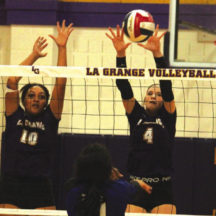 La Grange’s Cara Homer and Avery Griffin go up for a block in Friday’s match. Photos by Jeff Wick
