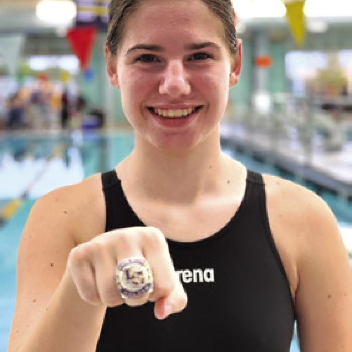Makenna Emmel powered to a new school record in the 100 backstroke.