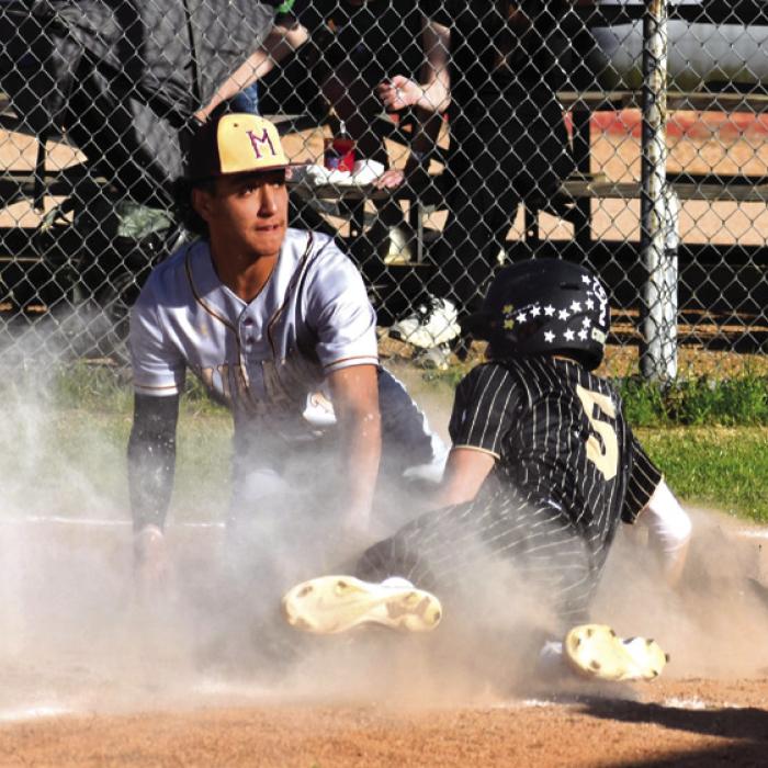 Round Top-Carmine’s William Neese slides into home plate in a cloud of dust last week against Milano. The Cubs lost to Milano Tuesday and Friday. Photo by Paul Kipp