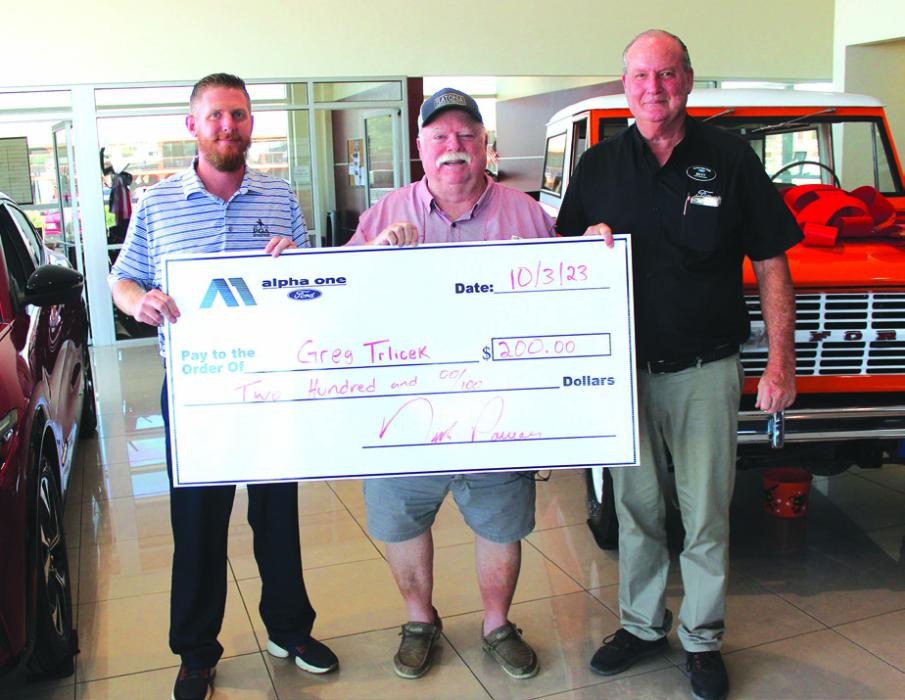 Greg Trlicek won last week’s reader football pick-it contest worth $200 by picking the winners of all 10 games correctly. He is shown here, center, accepting his prize money from Alpha One Ford’s Nick Power, left, and Ricky Dunk, right. The contest ballot appears in every Tuesday edition of The Fayette County Record.