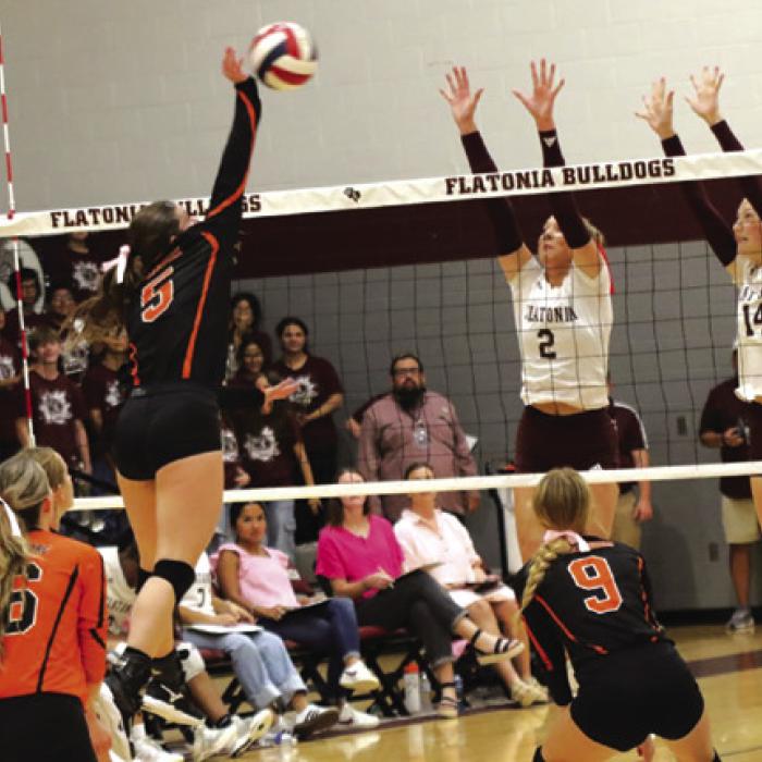 SHS’s Haylee Vacek spikes Tuesday against the block of Flatonia’s Summer Sodek and Quinn Arnett. Photo by Audrey Kristynik