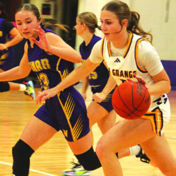 La Grange’s Campbell Cooper drives the ball down the court Friday. Photo by Jeff Wick