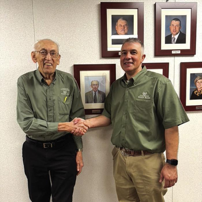 Bank President Chris Coufal, right, honored Gilbert Krause’s contributions with a retirement celebration held on the bank’s second floor.