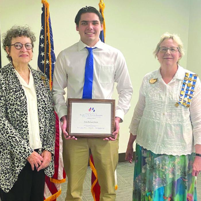 Lois Wink, Flag of the United States Committee Chair, Cole Stork, and Kim Joost, Parliamentarian filling in for the Regent.