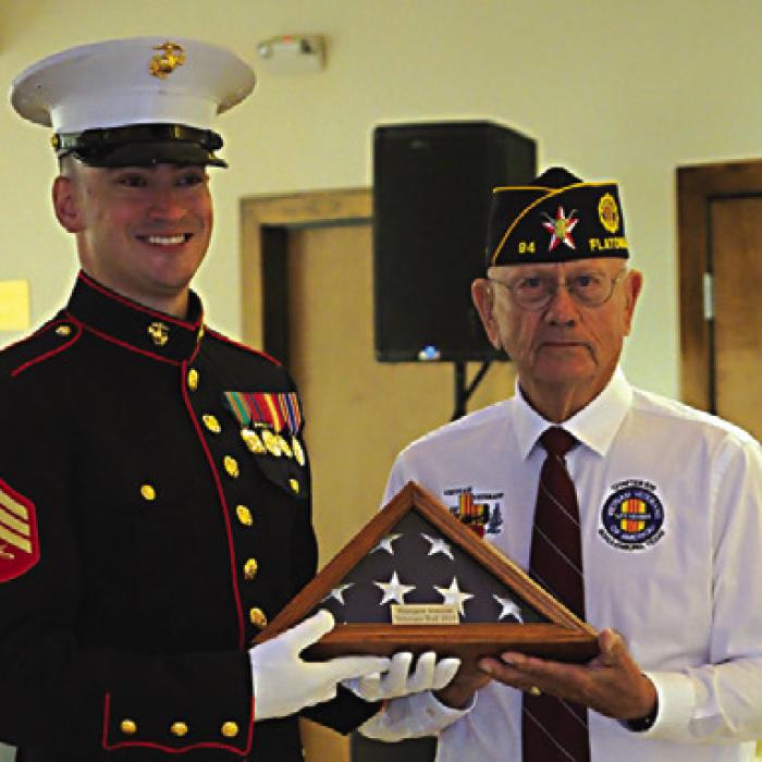 Shown here is Montana Ollie the youngest veteran present at 29 years old, received a folded US Flag (presented by Danny Vyvjala (Commander of Post 94).