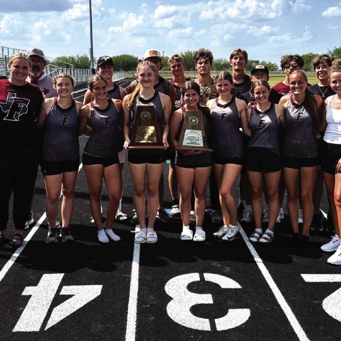 Members of the Fayetteville track team hold their area team title trophies after the meet last week.