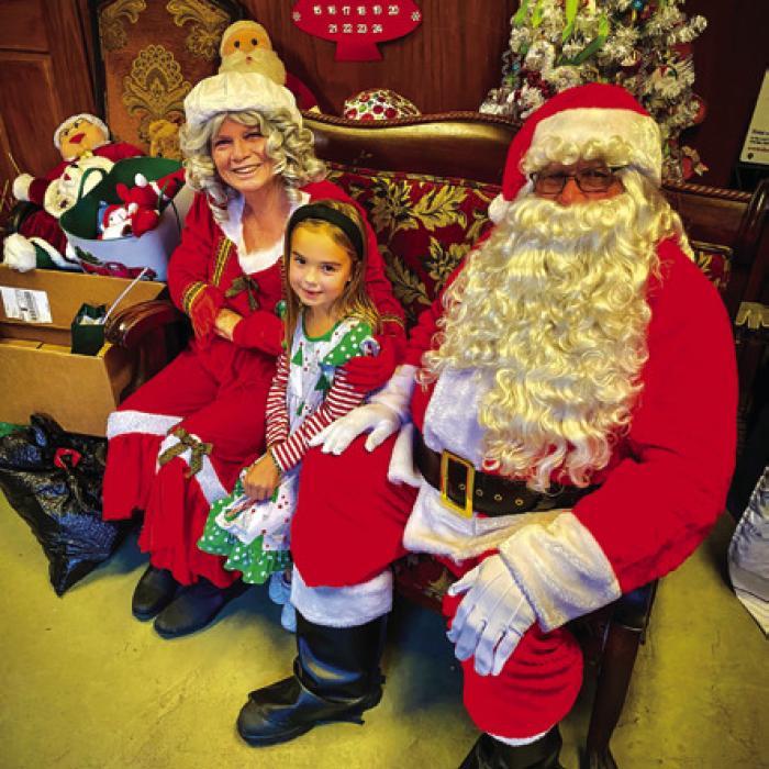 The Claus family and a visitor during the Fayetteville Country Christmas event Saturday.