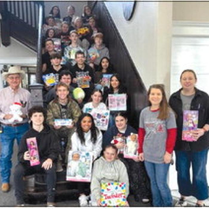 Chief Noviskie and Fayetteville ISD National Honor Society students with toys collected for Deputy Santa.