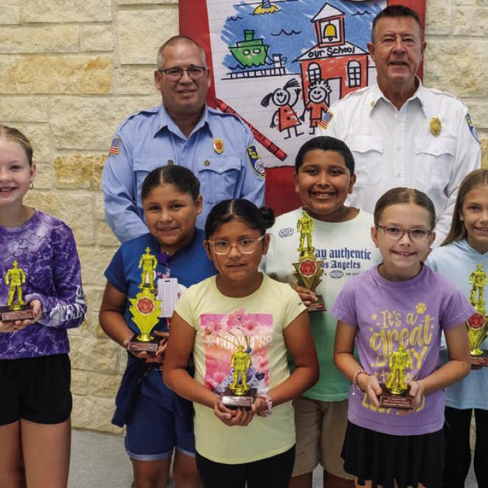 Fire poster winners from the third and fourth grade class at La Grange Elementary are (front, from left) Stella Mozisek-honorable mention, Patsy Lemus-winner, Ruthie Lemus-honorable mention, Leonardo Martinez-winner, Reagan McCullough-honorable mention, and Lauren Lloyd-winner. Also pictured are Captain Kenneth Chovanec and Fire Chief Frank Menefee of the La Grange Volunteer Fire Department.