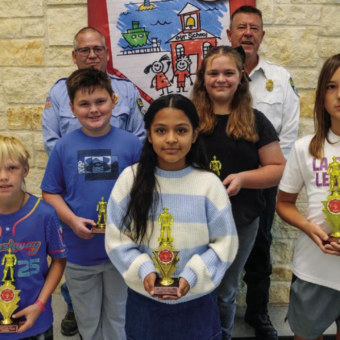 Fire poster winners from the fifth and sixth grade class at La Grange Elementary are (front, from left) Jacoby Zaruba-winner, Dana Barron-winner, Crew Price-winner, (middle row) Lillian Bruggerhonorable mention, Colton Kelley-honorable mention, and Berkley Hall-honorable mention. Also pictured are (bacl) Captain Kenneth Chovanec and Fire Chief Frank Menefee of the La Grange Volunteer Fire Department.
