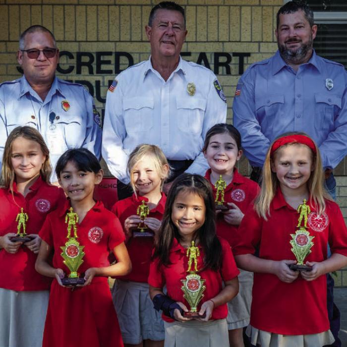 Fire poster winners from the first and second grade class at Sacred Heart School in La Grange were (front, from left) Reeanna Ramirez, Genesis Garcia and Sami Montgomery. Honorable mention awards went to (middle row) Hallie Hanna, Mayleigh Shelander and Cheyenne Morales. Also pictured are (back) Captain Kenneth Chovanec, Fire Chief Frank Menefee and Fireman Chris Kaspar of the La Grange Volunteer Fire Department.
