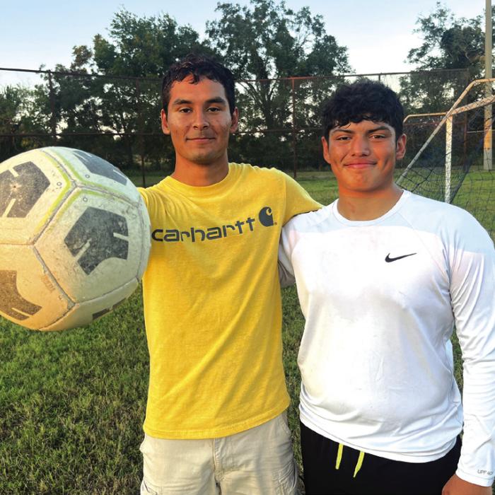 La Grange High School seniors Ramon Ortiz, left, and Matthew Olvera, right, are exhausted but still all smiles Tuesday evening after a full day of classes, followed by football practice, followed by leading a practice of their Optimist Club youth soccer team. Photo by Jeff Wick