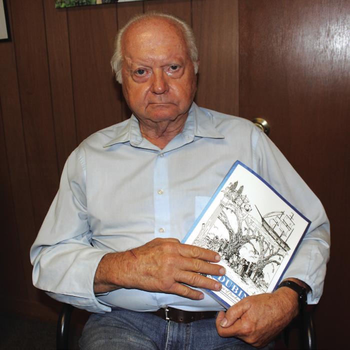 Former County Judge Ed Janecka holds a copy of his new book after dropping off a batch at The Fayette County Record this week. Photo by Jeff Wick