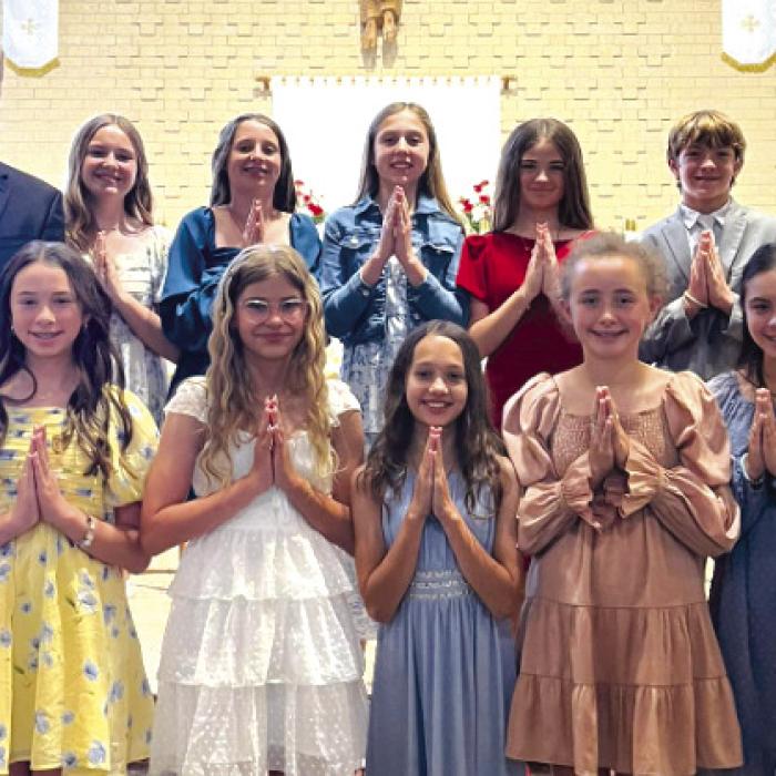 Class of 2026 - 6th Grade Graduates, front from left: Krislee Kallus, Marley Vasek, Sophie Janda, Emmy Neal, Ellery Bradford; back row: Fr. Chris Smith (Pastor, Sacred Heart Catholic Church and School), Helen Streiff, Adalyn Emmel, Hallie Gross, Chezni Berdoll, Ricky Greenwood, Ms. Cathy Zingelmann (6th Grade teacher).