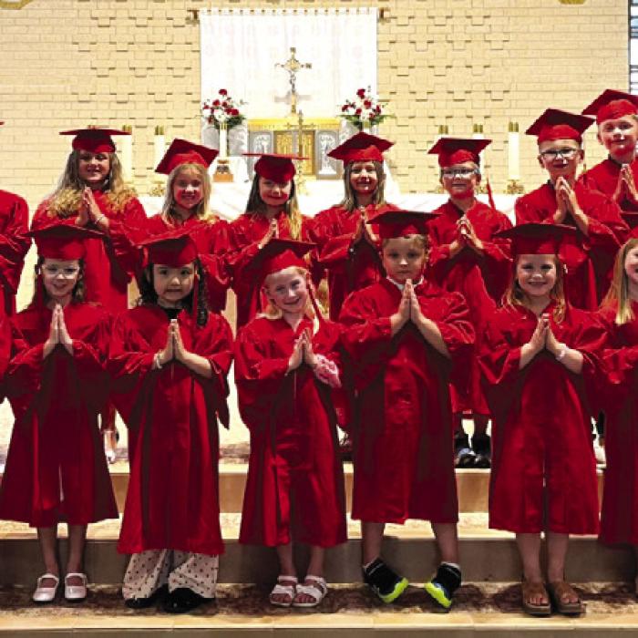 Kindergarten Graduates, front from left: Mrs. Ann Oviedo (Kinder teacher), Hayes Mayer, Lucas Navarro, Teagan Newton, Gracelynn Perez, Hailey Riding, Ethan Wagner, Julia Wied, Ella Zapalac, Kyle Zigal, Fr. Chris Smith; back row: Mrs. Robyn Weyand (aide), Cullen Berger, Laramie Blackwell, Willa Childs, Hazel Freedman, Madeline Gulash, Lawson Hatfield, Tanner Jecmenek, Hudson Klesel, and Oliver Kutilek.