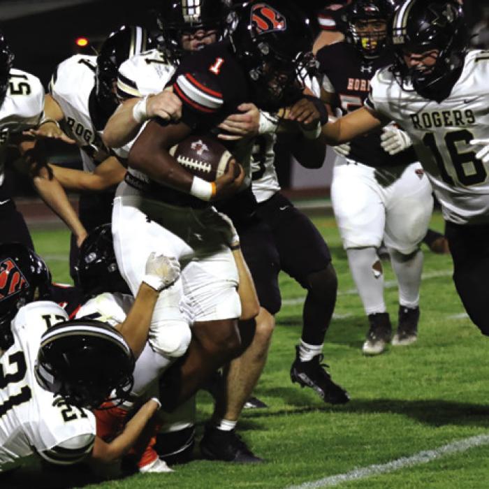 Schulenburg’s DaTerrion Houston carries several Rogers players with him as he runs the ball Friday. Houston rushed for a team-high 142 yards for the Shorthorns. Photo by Audrey Kristynik