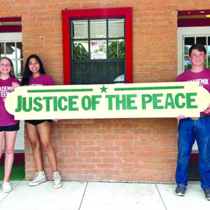 Elizabeth Faldyn, clerk, with students Reagan Moreau, Valerie Vera, Cooper Mau and JP Jamie Moreau.