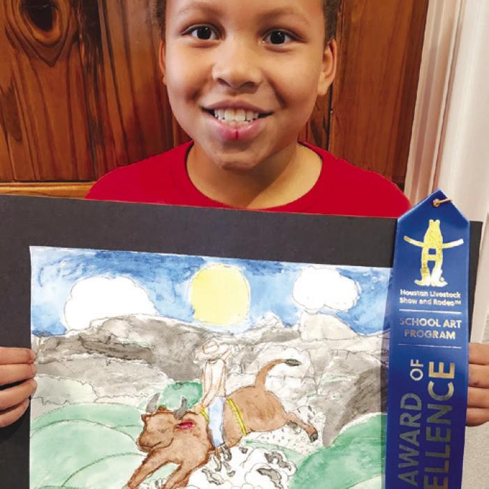 Amari Rhodes with his first place artwork from the Houston Livestock Show Art Contest.