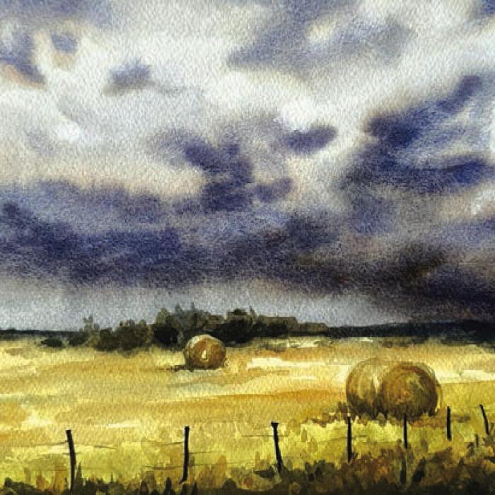 Allyson Hoffman’s watercolor “Bales and Brooding Skies.”