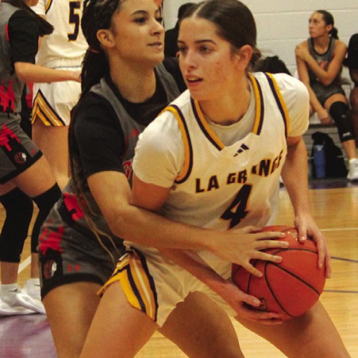 La Grange’s Macie Collier looks to make a pass against some tough defense from Gonzales Tuesday.