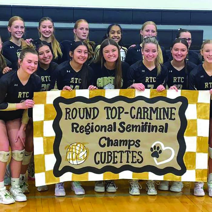 The members of the Round Top-Carmine volleyball team celebrate their victory Tuesday over Utopia in Seguin.