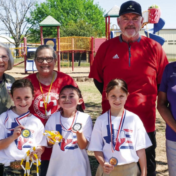 Winners of the girls division at Sacred Heart were (front, from left) Corbyn Blackwell-1st Place, Aryanna Gilbreath-2nd Place, and Winnie Schielack-3rd Place. Also pictured are Karen Forest of Fayette County helpers, second grade teacher Carolyn Weishuhn, P.E. coach David Wicke and La Grange Mayor Jan Dockery.
