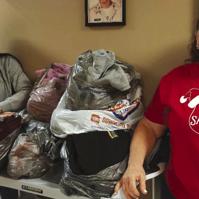 Receiving the donation at the clinic from Becky Leer (right) was Brittney Schneider, AMSA.