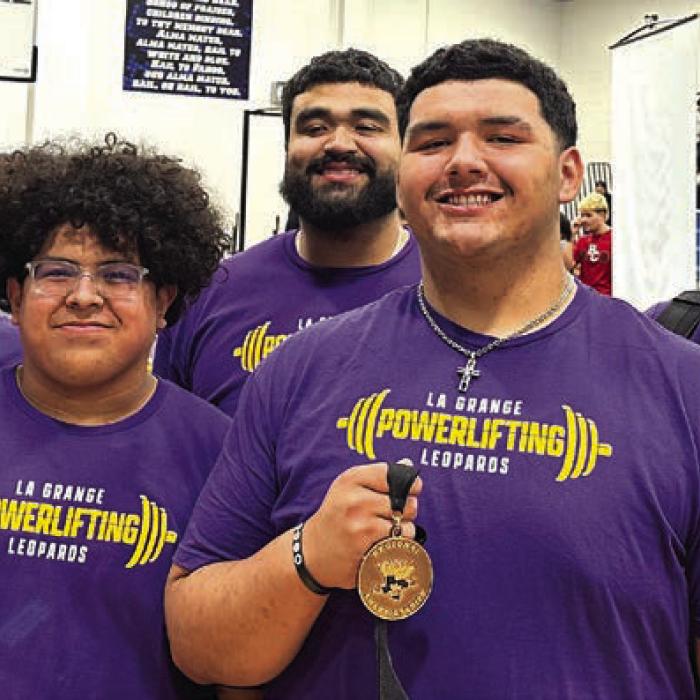 Left to right at regional powerlifting for La Grange – Coach Nick Parker, Erick Guevara with his second place medal, coach Frankie Saucedo, Javier Cuevas with his fourth place medal, and head coach Charles Otto.