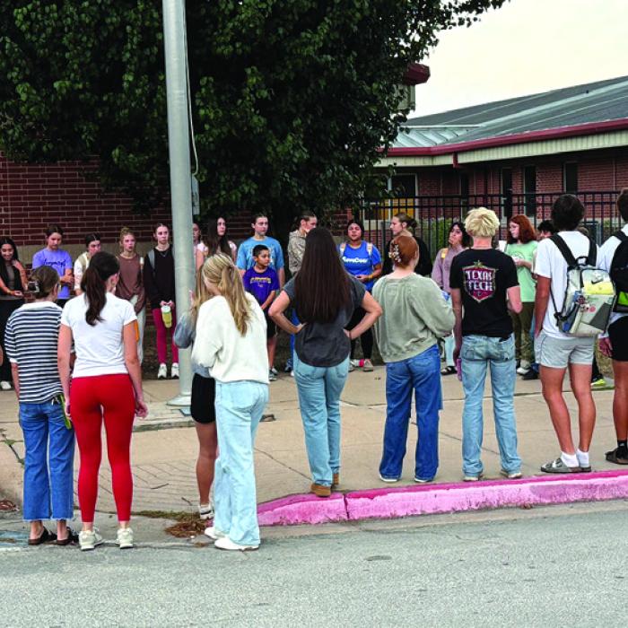 Wednesday several La Grange High School students attended the student-led Meet Me At The Pole prayer event before school. “It was the biggest turnout I had seen for years, with about 40 students attending, from all high school grades,” one teacher said. Junior Macie Collier led the students in prayers and read scripture and some other students led the group in prayer too. Photo by Deandra Baker