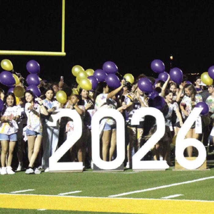 A flaming LG at the stadium, left, and the seniors gather for a balloon release at the conclusion of the pep rally, right. Photos by Jeff Wick
