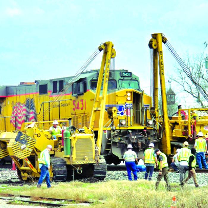 Crews lift the train back onto the track in Fayetteville.