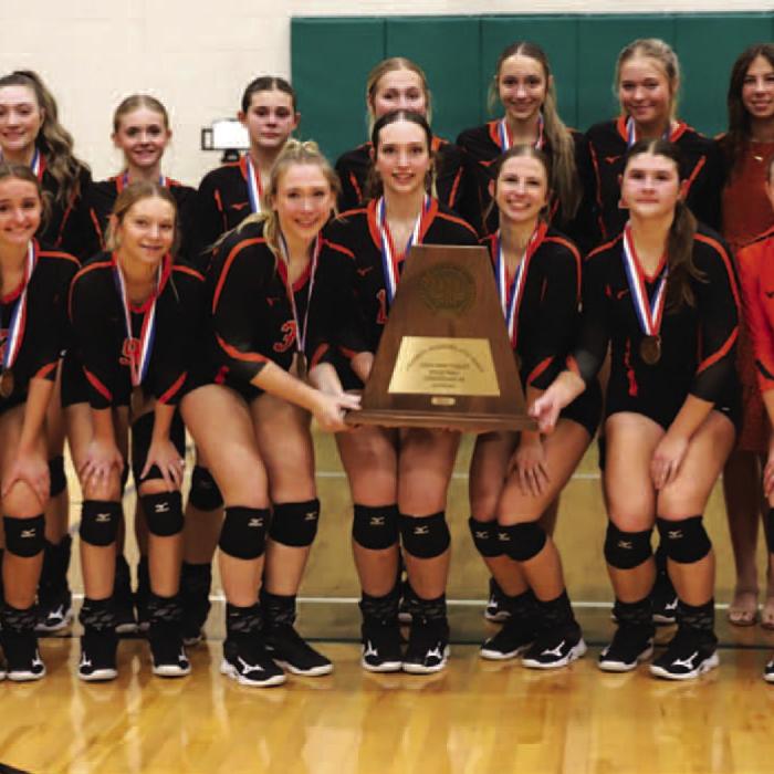 With state bronze medals around their necks, the members of the Schulenburg volleyball team pose with their state semi. nal trophy after falling in Saturday's match to Jewett Leon. Photo by Audrey Kristynik