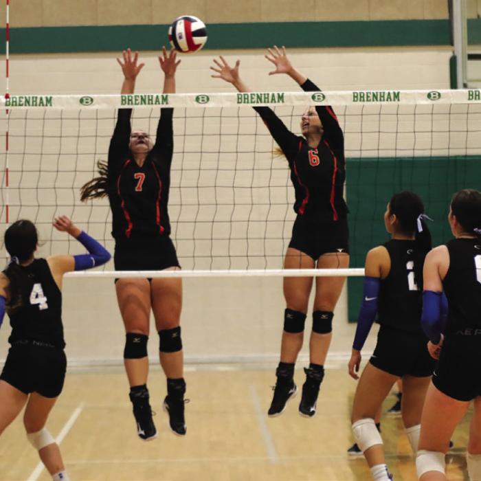 Schulenburg’s Landry Zapalac, left, and Clara Magliolo, right, jump to try to block a Jewett Leon hit in Saturday’s state semifinal. Photo by Audrey Kristynik